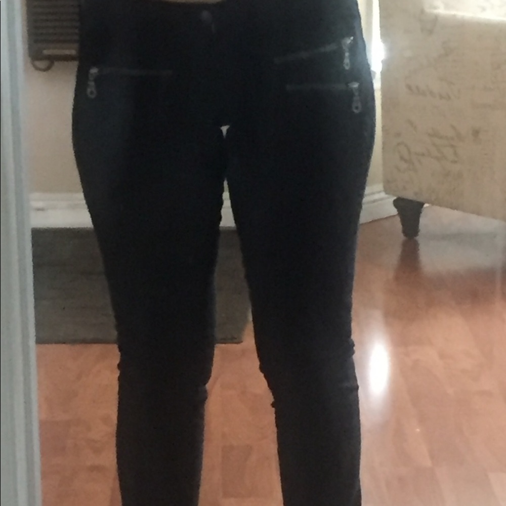 Black jeans with zipper details.
